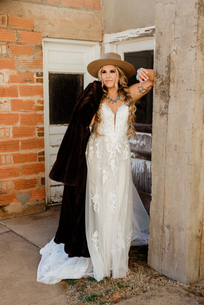 bride with cowboy hat and fur coat