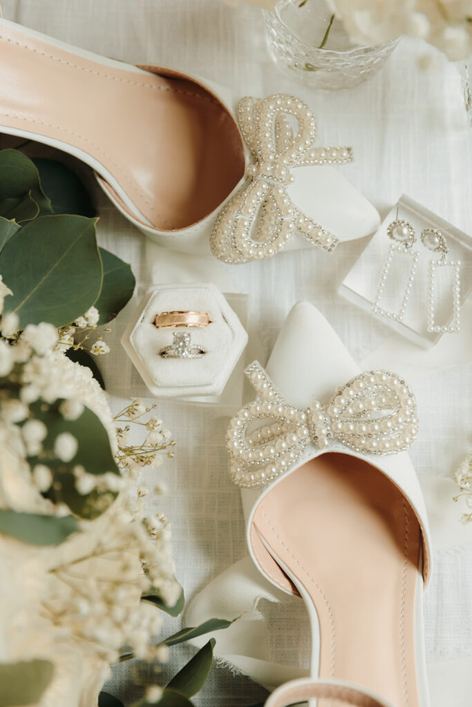 White pearl wedding shoes and white roses