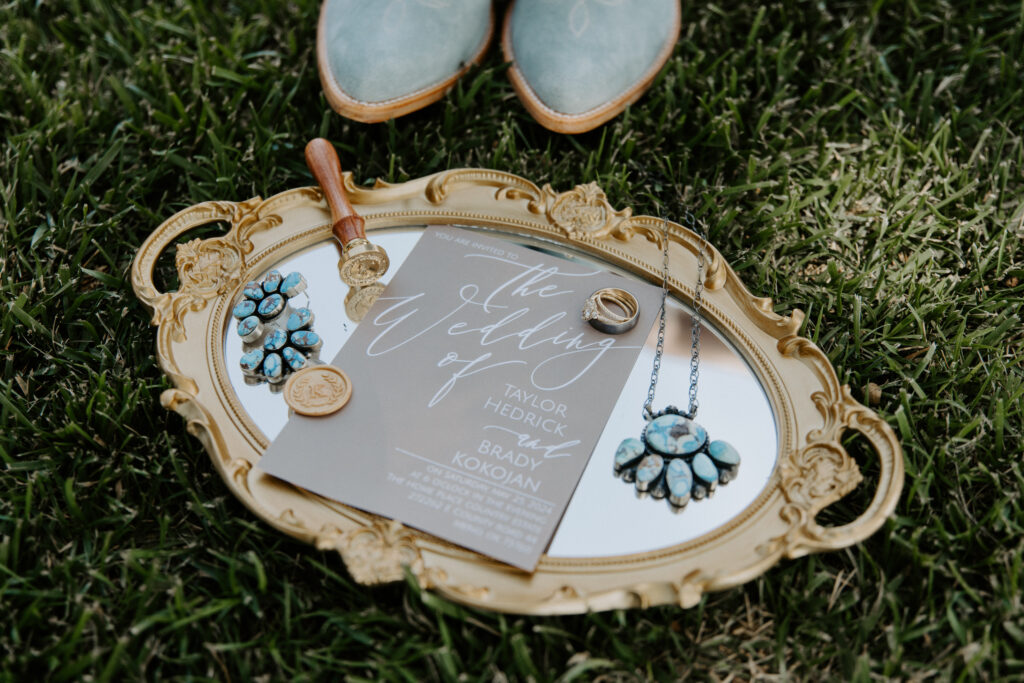 mirror, turquoise jewelry, and the wedding invitation