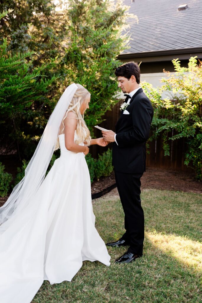 first look photo reading their vows