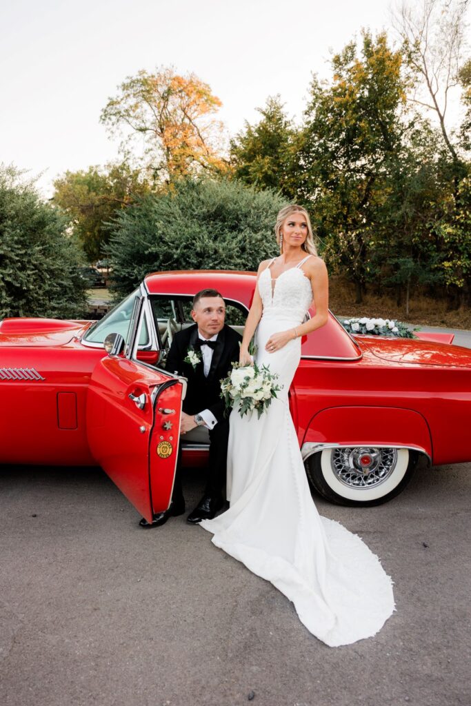 Wedding day timeline | Wedding couple posing with red car