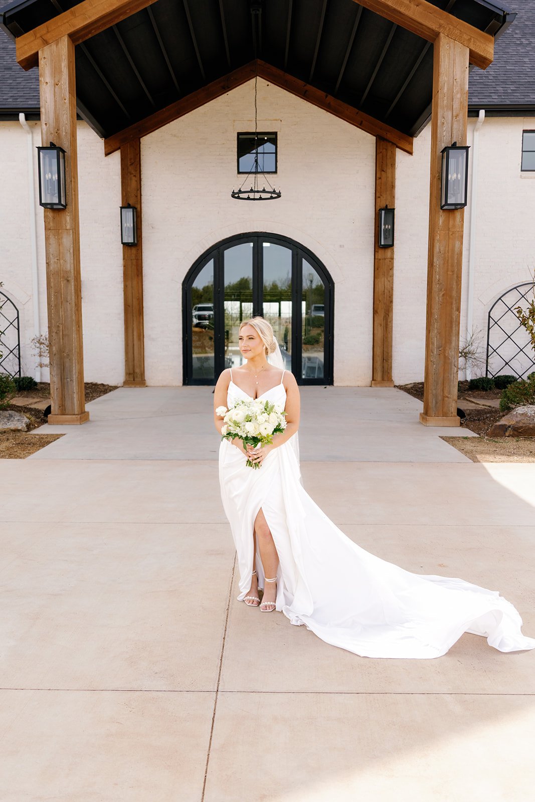A bridge posing for a picture outside of the Range one of the wedding venues in OKC