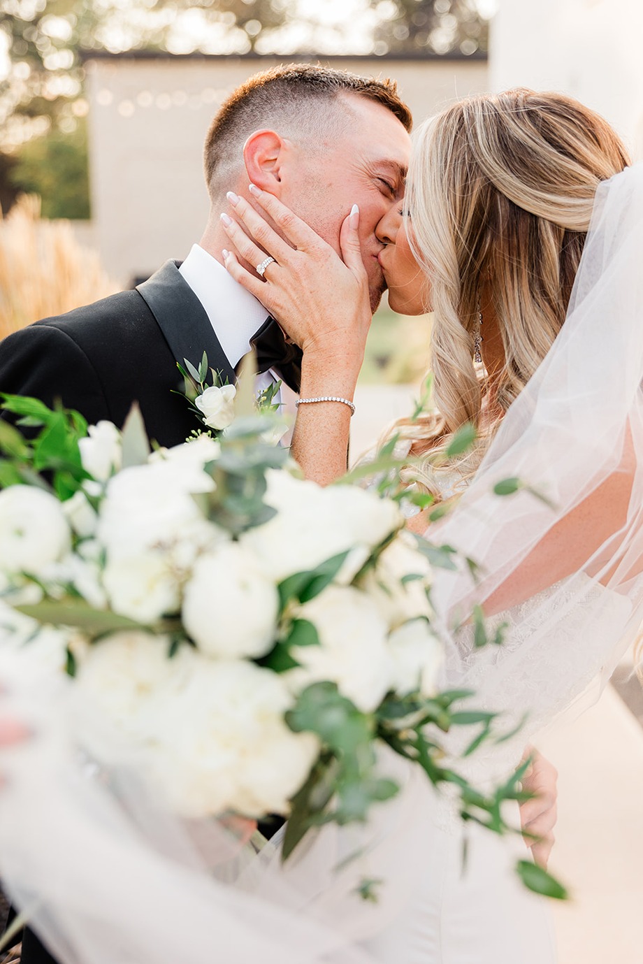 a bride and groom kissing at their wedding planned by sweet moments by dalana an oklahoma wedding planner