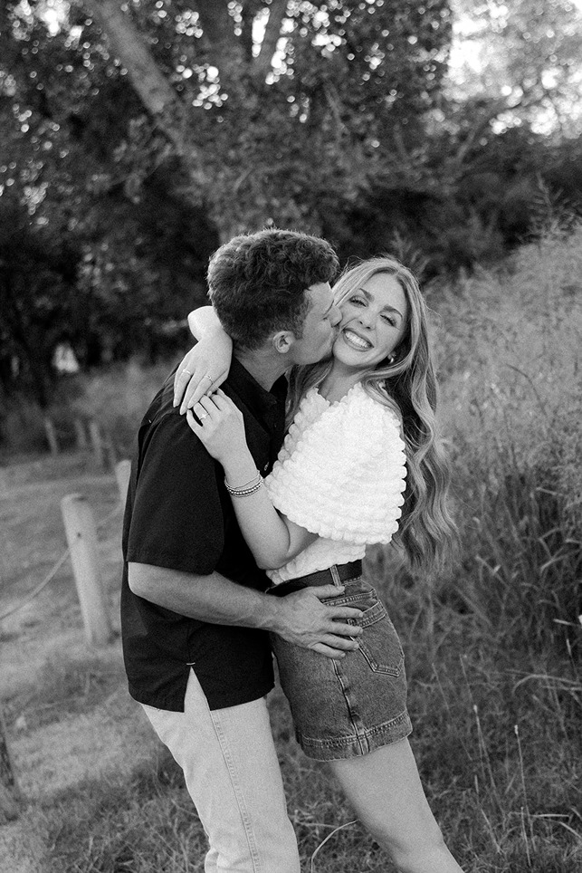 Couple laughing together during engagement session with OKC engagement photographer Bridget Blood